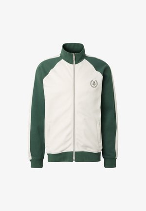 Veste zippée blanche et vert foncé avec col montant, poches latérales et petit emblème brodé sur le côté gauche de la poitrine.