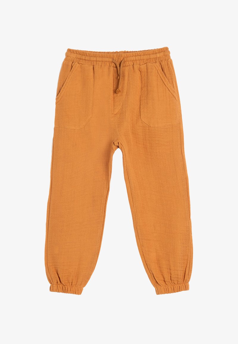 Orange, lette bukser med elastisk talje, snøre og to frontlommer. Elastiske manchetter ved anklerne for en tætsiddende pasform.