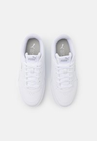 White athletic shoes with a smooth leather upper, round toe, lace-up front, and padded collar. Features subtle logo on tongue and side.