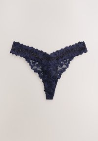 Marineblå blondeg-strengtrusser med blomsterprint, takkede kanter og indviklede detaljer. Blødt stof med en let, gennemsigtig tekstur.