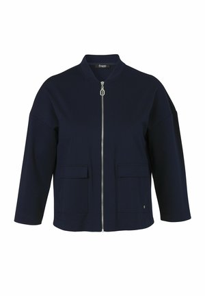 Veste zippée bleu marine à manches longues, deux poches avant à rabat et col rond, présentée sur fond blanc.