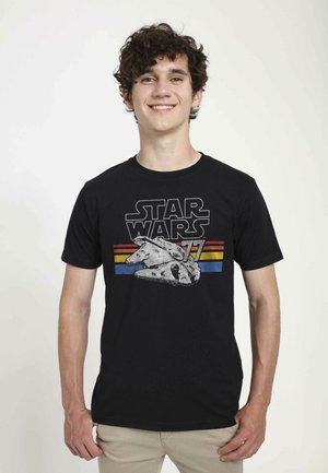 Black cotton t-shirt featuring a graphic of the Millennium Falcon with "STAR WARS" text and colorful horizontal stripes in blue and yellow.