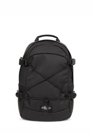 Sac à dos Eastpak noir avec bretelles réglables, cordons élastiques à l'avant, et une poignée de transport supérieure sur fond blanc.
