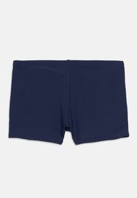 Calções de banho masculinos azul marinho com cintura plana e costura central, exibidos sobre um fundo branco liso.