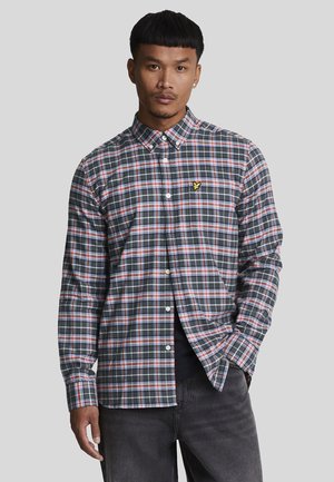 Long-sleeve plaid shirt in dark navy, red, and white. Features a button-down collar and embroidered logo on the chest. Cotton fabric.