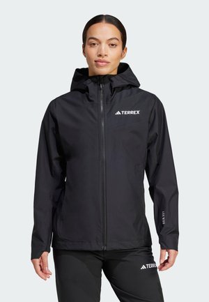 Sort vandtæt jakke med lynlås, justerbar hætte og "TERREX" logo på brystet. Har lange ærmer og elastiske manchetter.