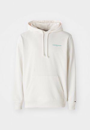 Hoodie v kremni barvi s sprednjim žepom, kapuco s vrvico in vezenim logotipom "tommy jeans" v svetlo modri barvi. Mehka bombažna tkanina.