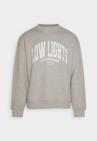 Sudadera gris con cuello redondo, ajuste holgado y puños acanalados. Presenta texto impreso en blanco: "LOW LIGHTS" y "LOW LIGHTS STUDIOS."
