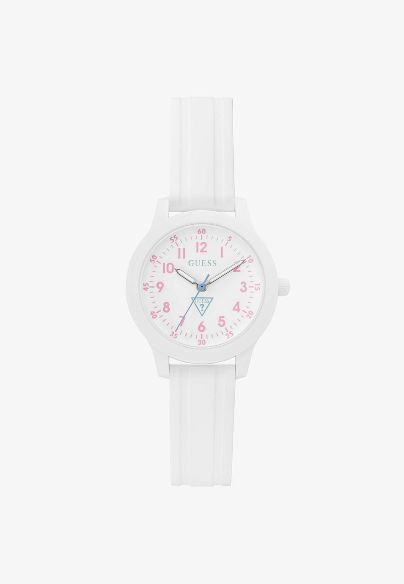 Montre-bracelet à bracelet en silicone blanc avec chiffres roses, aiguilles des heures et minutes argentées, aiguille des secondes bleue, et logo Guess sur le cadran blanc.