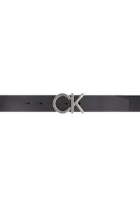 Black leather belt featuring a silver circular buckle with "CK" logo. Designed with multiple holes for size adjustment. Smooth texture.
