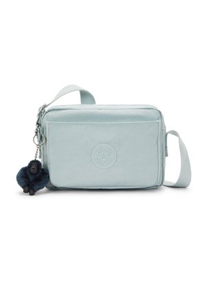 Light blue rectangular bag with soft fabric, featuring a front pocket and a furry gorilla charm attached to the zipper. Adjustable strap included.