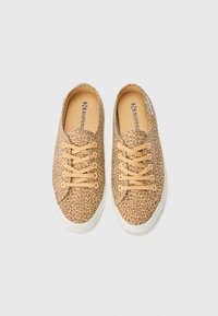 Canvas sneakers with a leopard print in shades of brown, beige laces, and a white rubber sole, featuring a round toe and minimal branding.