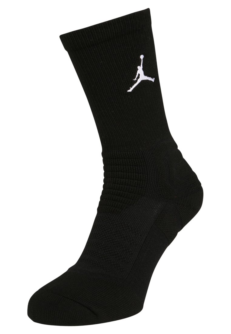 Calza sportiva nera con texture a coste, suola imbottita e logo Jumpman bianco ben visibile sul lato.