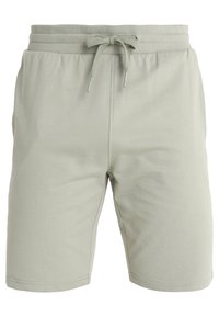Shorts vert clair en tissu doux, dotés d'une taille élastique avec un lien, d'un design simple, et sans poches ni motifs visibles.