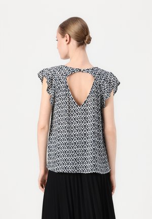 Black and white patterned top with a V-back and ruffled sleeves. Made from lightweight fabric, featuring a button closure at the back.