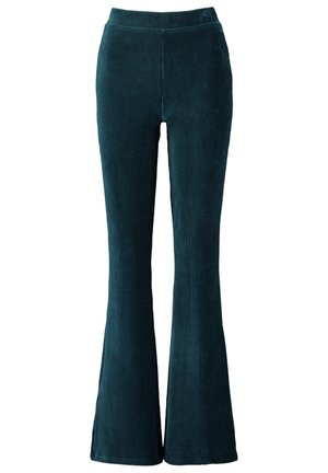 Dunkelgrüne Cordhose mit hoher Taille, kombiniert mit einem figurbetonten Top und ausgestellten, weiten Beinen.