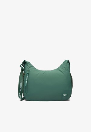 Zielona torba na ramię Reebok z regulowanym paskiem, przednią kieszenią na zamek i małą naszywką z logo na białym tle.