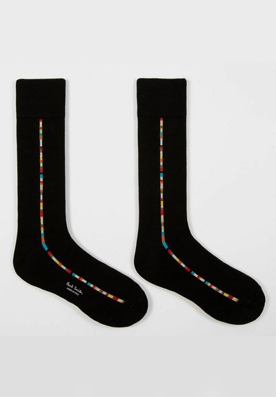 Calze nere realizzate in un tessuto morbido, con un design a strisce colorate lungo il lato esterno. Polsino a coste e superficie liscia in tutto il prodotto.