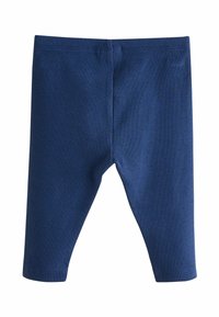 Leggings côtelés bleu foncé avec une taille élastique, offrant un ajustement près du corps et des coutures renforcées le long des coutures.