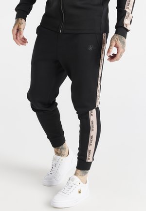 DYNAMIC - Tracksuit bottoms - black