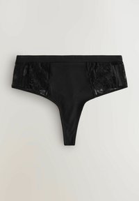 String noir en tissu lisse à l'avant et avec des panneaux en dentelle de chaque côté présentant des motifs floraux. Le design est minimal, sans aucun accessoire.