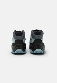 Black and light blue outdoor shoes with mesh upper and curved sole. Features rubber accents and textured detailing on the heel and sides.