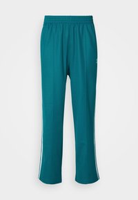 BAGGY - Tracksuit bottoms - legacy teal