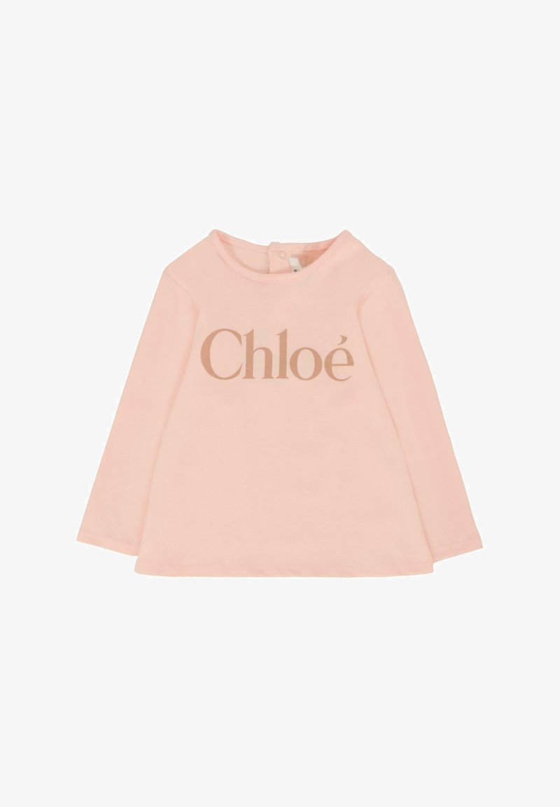 Różowa, długorękawowa bluzka dla małego dziecka, wykonana z miękkiej bawełny, z okrągłym dekoltem i złotym nadrukiem logo "Chloé" z przodu.