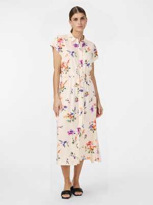 Floral midi dress in cream, featuring a collar, short sleeves, cinched waist, and diverse colorful flower patterns. Black slide sandals.
