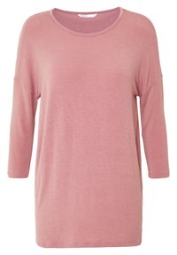 Top a maniche lunghe rosa chiaro realizzato in tessuto morbido e texturizzato. Presenta un colletto rotondo e una vestibilità rilassata con aperture laterali per facilitare i movimenti.
