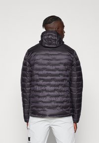 Black puffer jacket with a quilted design, hood, and contrasting shoulder panels. Made from shiny, lightweight material; features a straight hem.