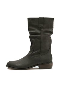 Dark green leather knee-high boot with a slouchy design, rounded toe, low stacked heel, and tab detail at the top. Smooth texture.