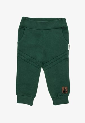 Ciemnozielone bawełniane spodnie dresowe z prążkowanym paskiem w talii, bocznymi kieszeniami i skośnymi przeszyciami. Posiadają brązową metkę z wzorem namiotu.