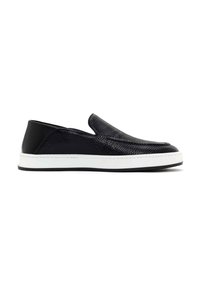 Black slip-on shoes made of textured leather with a smooth black accent at the heel. Features a white midsole with black detailing.