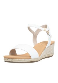 Sandale compensée blanche avec un bout ouvert et une bride à la cheville, présentant un dessus lisse et un détail en jute tissé sur le talon pour une texture.