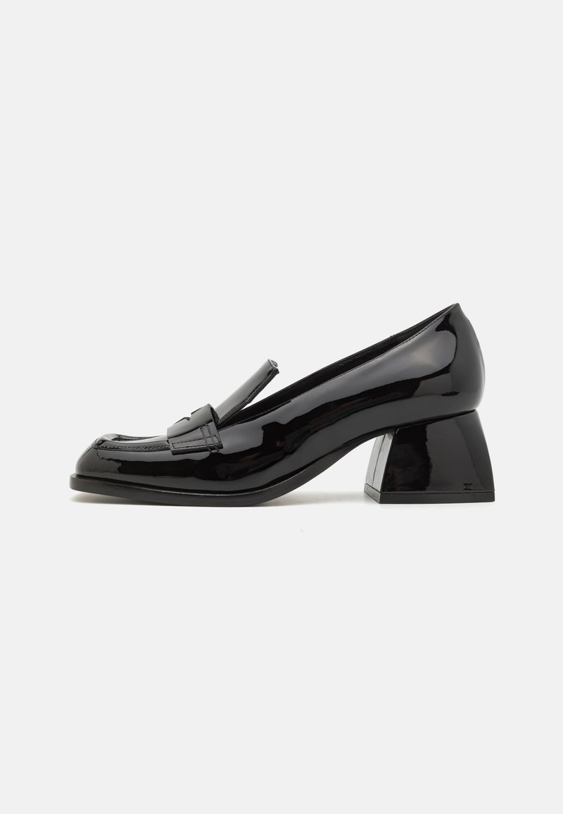 Black patent leather loafer with a block heel, featuring a stitched toe and polished accents. Smooth, shiny texture; rounded shape.
