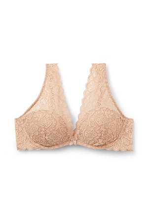 Huisdraad beha in een zachte nude kleur met een golvende ontwerp, ondersteuning met onderdraad en bloemrijke patronen met een klein strikje in het midden.