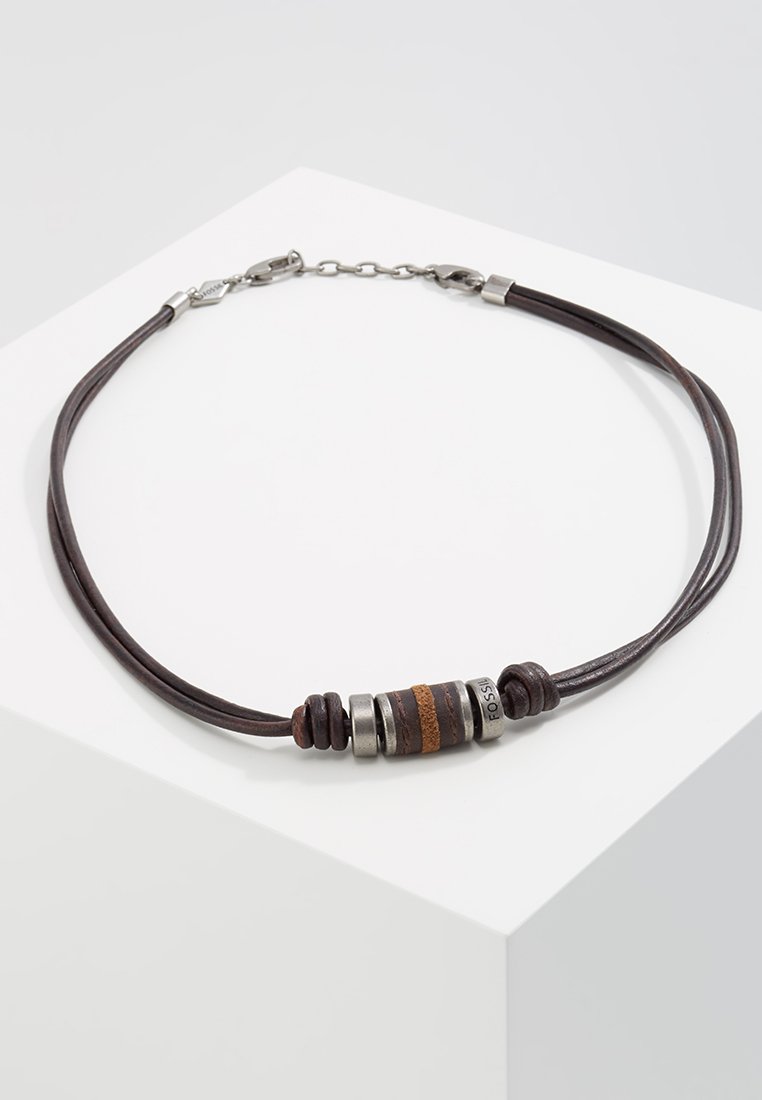 Brown leather necklace featuring metal and textured beads in various colors, with a lobster clasp closure and chain extension.