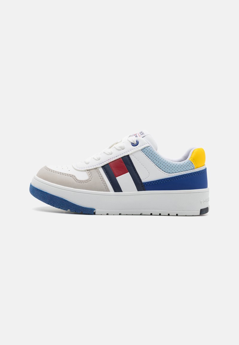 White sneaker with gray, blue, and red accents. Features a smooth leather upper, perforated panels, and a textured rubber sole.