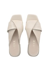 Beige leather slide sandals with crossed upper straps, square toe design, and minimalistic flat sole; embossed brand name on insole.