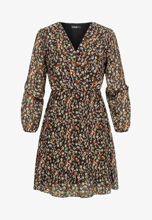 Květinové šaty s černým pozadím, s bílými, oranžovými a zelenými vzory. Dlouhé nabírané rukávy, výstřih do V a volánkový lem.