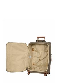 Valise rigide de couleur beige atténuée avec une poignée tan, intérieur spacieux avec un revêtement beige et des sangles ajustables pour un rangement sécurisé.