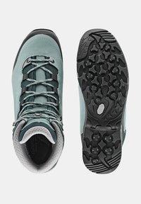 Buty trekkingowe w jasnym błękitnym skórze z czarnymi akcentami i szarymi sznurowadlami. Teksturowana gumowa podeszwa z wyraźnymi wzorami bieżnika zapewnia przyczepność.