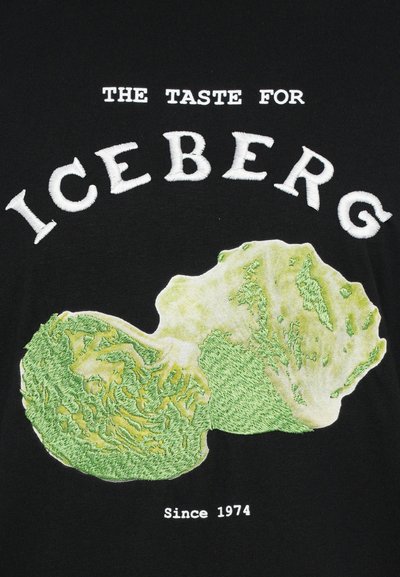 Black t-shirt featuring white embroidered text "THE TASTE FOR ICEBERG" above a detailed green iceberg lettuce graphic, with "Since 1974" below.