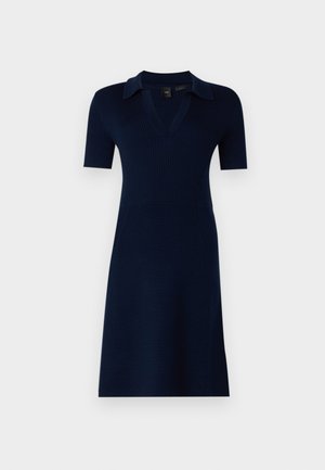 Pletena tamnoplava haljina s prilagođenim korzetom, kratkim rukavima i V-izrezom. Ima rebrastu teksturu i lepršavu suknju.