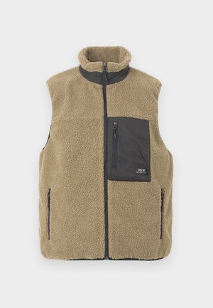 Gilet senza maniche in pile beige con colletto nero, tasche sul petto e laterali con zip, chiusura frontale con zip.