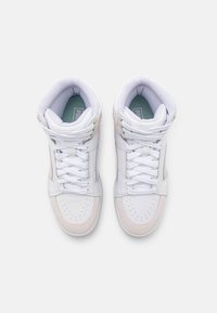 White high-top sneakers with leather and mesh materials, featuring pink accents, round toe, perforated design, and lace-up closure.