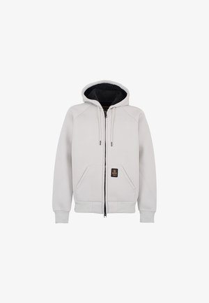 Felpa con zip grigia chiara, foderata in nero, con lacci regolabili, due tasche frontali, polsini e orlo a coste, presenta una toppa con logo.