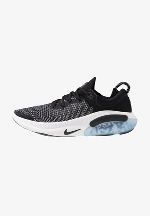 Black and white athletic shoe with a mesh upper, round toe, subtle speckled pattern, and clear, cushioned sole for comfort.
