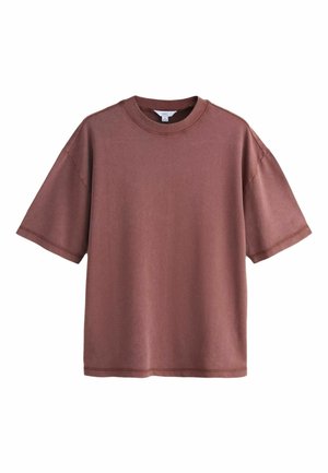 Oversized kortærmet T-shirt med rund hals i ensfarvet, dæmpet mauve, vist fladt på en hvid baggrund.